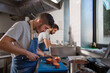 © ADDICTIVE STOCK - Young ethnic male cooks working together in restaurant kitchen