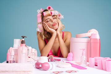 Wall Mural - Young woman grimacing while sitting at table with beauty products