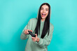 © deagreez - Photo of impressed young brunette lady play wear green sweatshirt isolated on teal color background