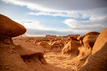 Wall Mural - Hoodoo formations, created by sandstone erosion, in a desert landscape in Goblin Valley State Park on a rainy spring day.