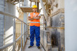 © Kostiantyn - Happy African engineer standing at industrial site