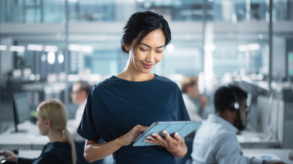 Aufkleber - Successful Businesswoman in Stylish Dress Using Tablet Computer, Standing in Modern Diverse Office Working on Financial, Business and Marketing Projects. Portrait of Beautiful Asian Manager.