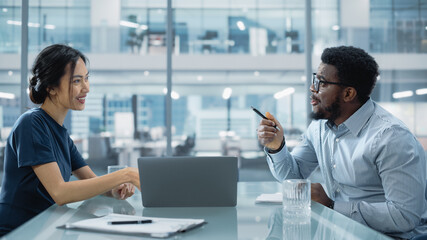 Multiethnic Diverse Office Conference Room Meeting: Team of Two Creative Entrepreneurs Talk, Discuss Growth Strategy. Stylish Young Businesspeople work on Investment in Real Estate and Commodities.