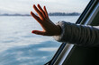 © ADDICTIVE STOCK - Crop female tourist touching window in boat