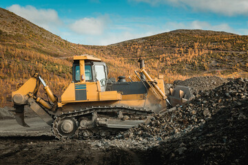 Wall Mural - A bulldozer works at a gold mining site.