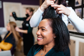 Middle aged African American woman enjoying in modern hair salon. Beauty, fashion concept.