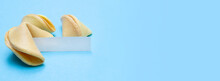 Banner With Fortune Cookies On A Blue Background And Place For Text. Mockup. Blank Paper For Writing A Fortune. Copy Space.