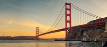 A Panoramic View Of A Golden Bridge At Sunset In San Francisco