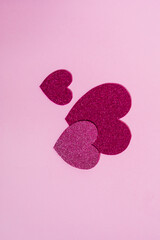 Wall Mural - Heart shapes with glitter in different colors on a purple background in combination with ring box, chocolate or red rose. Nice and simple Valentine's day or engagement concept,