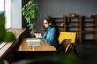 © DimaBerlin - Woman writer, student, copywriter or freelancer use smartphone at workplace. Busy female businesswoman read message in mobile phone working remotely from coworking space. Digital technology concept