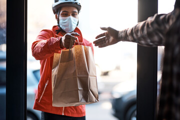 Wall Mural - We've got you covered during lockdown. Shot of a masked man delivering a food package.