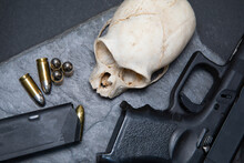 Skull And Pistol With Bullets Against A Black Stone Background (monkey Skull )