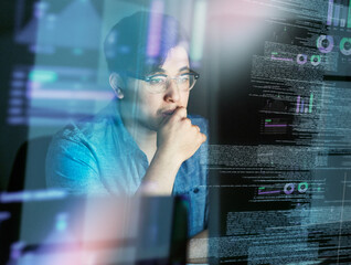 thinking about the code. cropped shot of a young computer programmer looking through data.