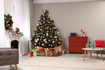 Poster - Beautiful Christmas tree and gifts near fireplace in festively decorated living room