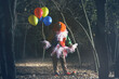 © New Africa - Terrifying clown with air balloons outdoors at night. Halloween party costume