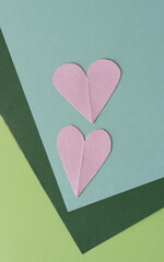 two pink hearts on a paper background