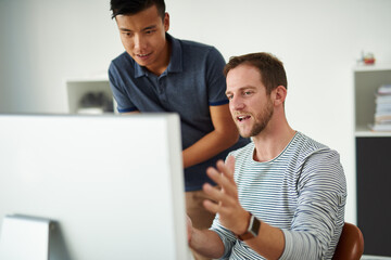 I think we've got it.... Cropped shot of two designers working together on a project in an office.