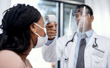 Aufkleber - Getting screened for everyone's safety. Shot of a doctor taking a patient's temperature with an infrared thermometer.