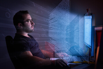 He's embedded in the code. Cropped shot of a young computer programmer looking through data.