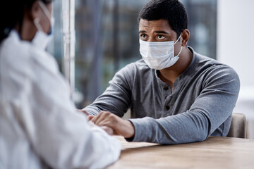 Aufkleber - How bad is it, doctor. Shot of a young man holding hands with a doctor during a consultation.