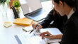 © bongkarn - A female financial boss briefing an assignment to her employee.
