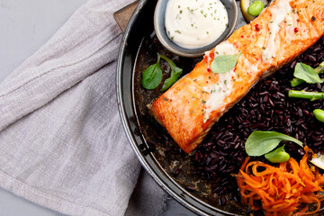 Wall Mural - Baked salmon with asparagus and black rice.