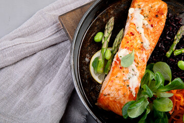 Wall Mural - Baked salmon with asparagus and black rice.