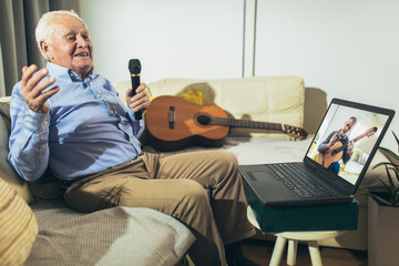 Senior man using microphone and singing karaoke