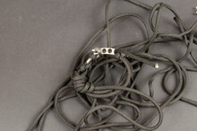 Paracord With Braided Clasp And Rigging Strap Lying Chaotically.