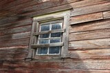 Fototapeta  - Dirty window in weathered, old, abandoned wooden barn. 