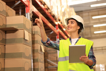 Poster - Woman with tablet working at warehouse. Logistics center