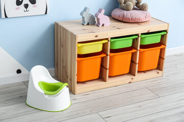 Wall Mural - White potty and drawers on grey wooden floor near color wall