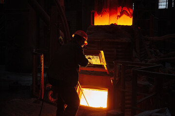 Wall Mural - Metallurgist steelmaker takes a sample of liquid metal from a ladle. Steel ladle degassing unit VD  VOD. Steel production. Metallurgy. Industry