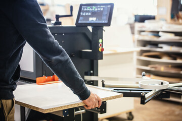 male craftman is working with a edge banding machine