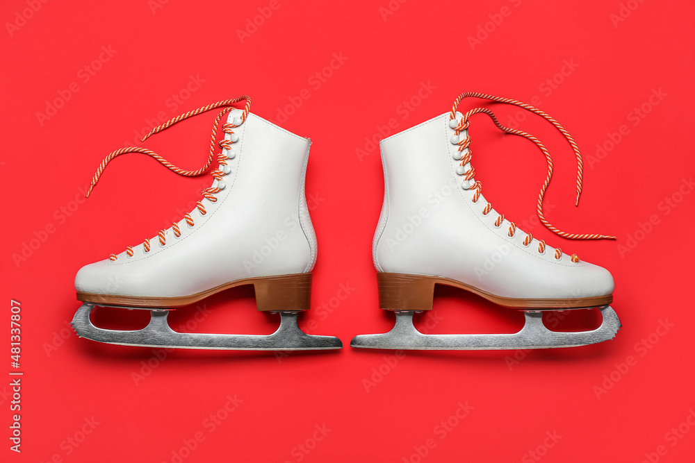 Ice skates on red background