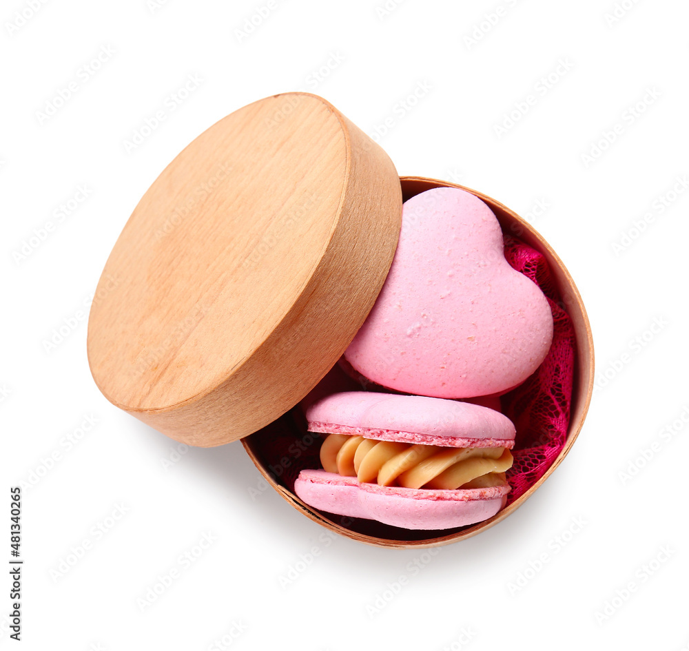 Box with tasty heart-shaped macaroons on white background