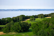View over the golfcourse at  Kullaberg mountain in Skåne, Sweden. View from a hiking trail in the natural reserve. Golf på kullen. In the distance, Bjärehalvön across the sea. Baltic sea, scenic view