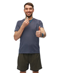 Wall Mural - fitness, sport and healthy lifestyle concept - smiling male trainer or referee with whistle showing thumbs up over white background