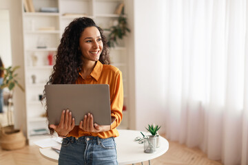 Woman Holding Laptop Working Online Standing Looking Aside Smiling Indoor