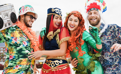 Wall Mural - Happy dressed people celebrating at carnival party dancing together - Focus on faces