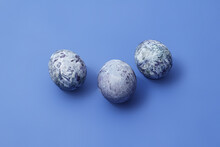 Easter Marbled Purple Eggs On Blue Background