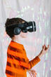 © ADDICTIVE STOCK - Boy exploring cyberspace in VR glasses