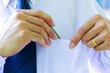 Young businessman Hand holding a pen in the pocket of a white long-sleeved shirt. Use a blue necktie. with high self-confidence Ideas for Happy Executives or Employees.