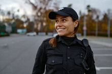 Portrait Of Smiling Police Woman On Street