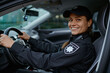 Side view portrait police woman driving car