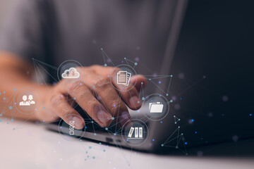 Leinwandbilder - Businessman is using a computer to think about how to keep track of documents, how to keep records, how to keep files organized, how to access files, and more.