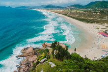 Joaquina Beach With Rocks And Blue Ocean With Waves In Brazil