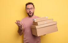 Middle Age Man Feeling Extremely Shocked And Surprised. Packages Boxes Concept