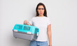 © kues1 - pretty hispanic woman feeling sad and whiney with an unhappy look and crying. pet travel carrier concept