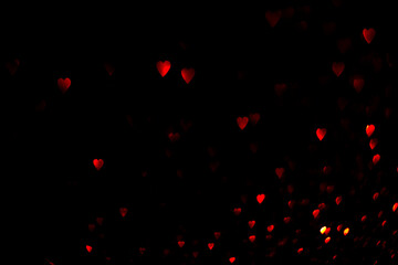 Wall Mural - Red hearts, blurred bokeh lights on black background. Glitter sparkle for valentines day. Overlay for your design